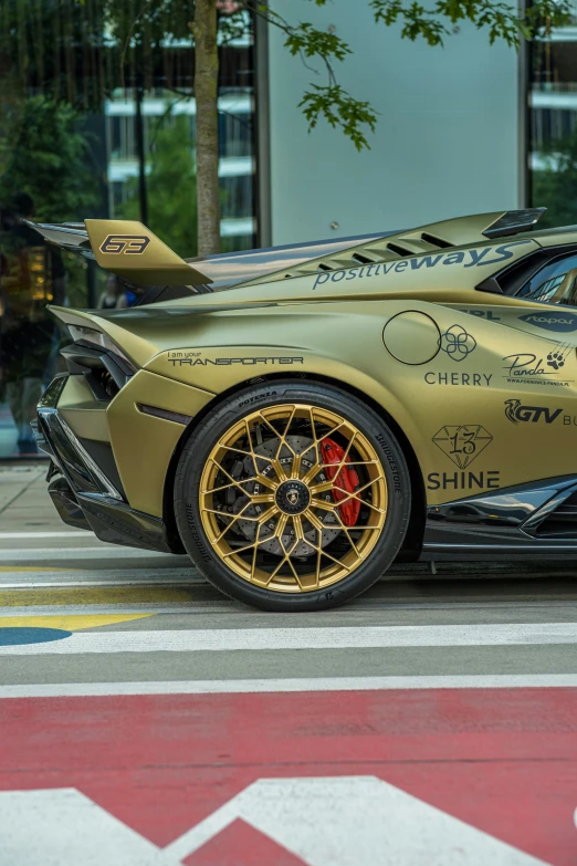 a gold colored sports car with writing on it