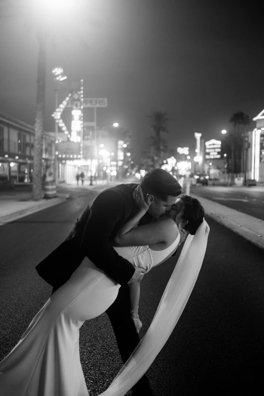 a black and white po of a bride and groom