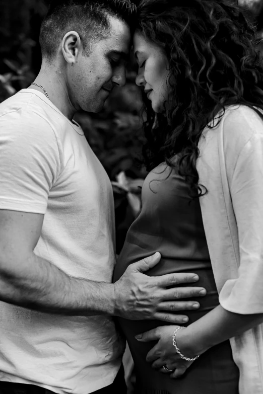 a man and woman holding their stomachs while looking at each other