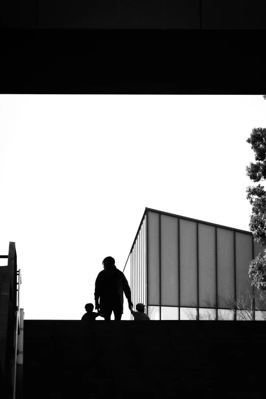 a man stands at the top of a roof