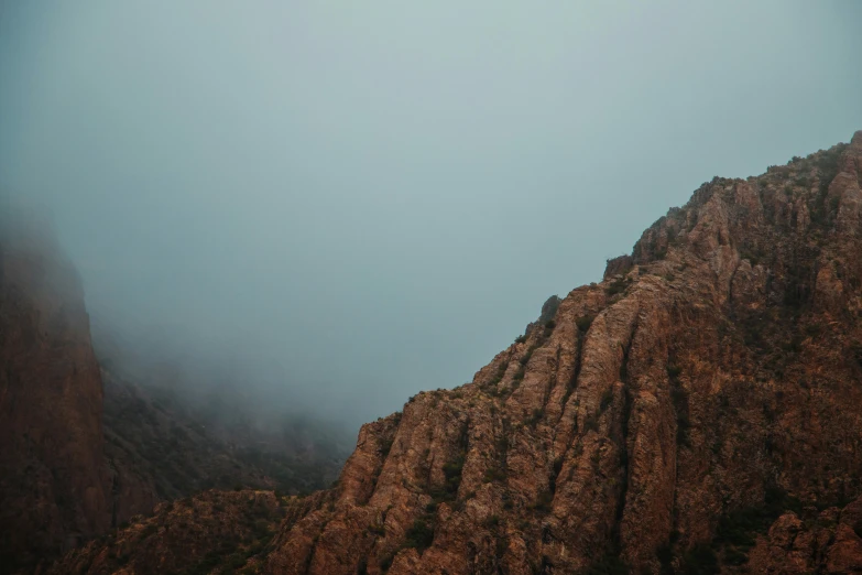 the mountains look very tall in the fog