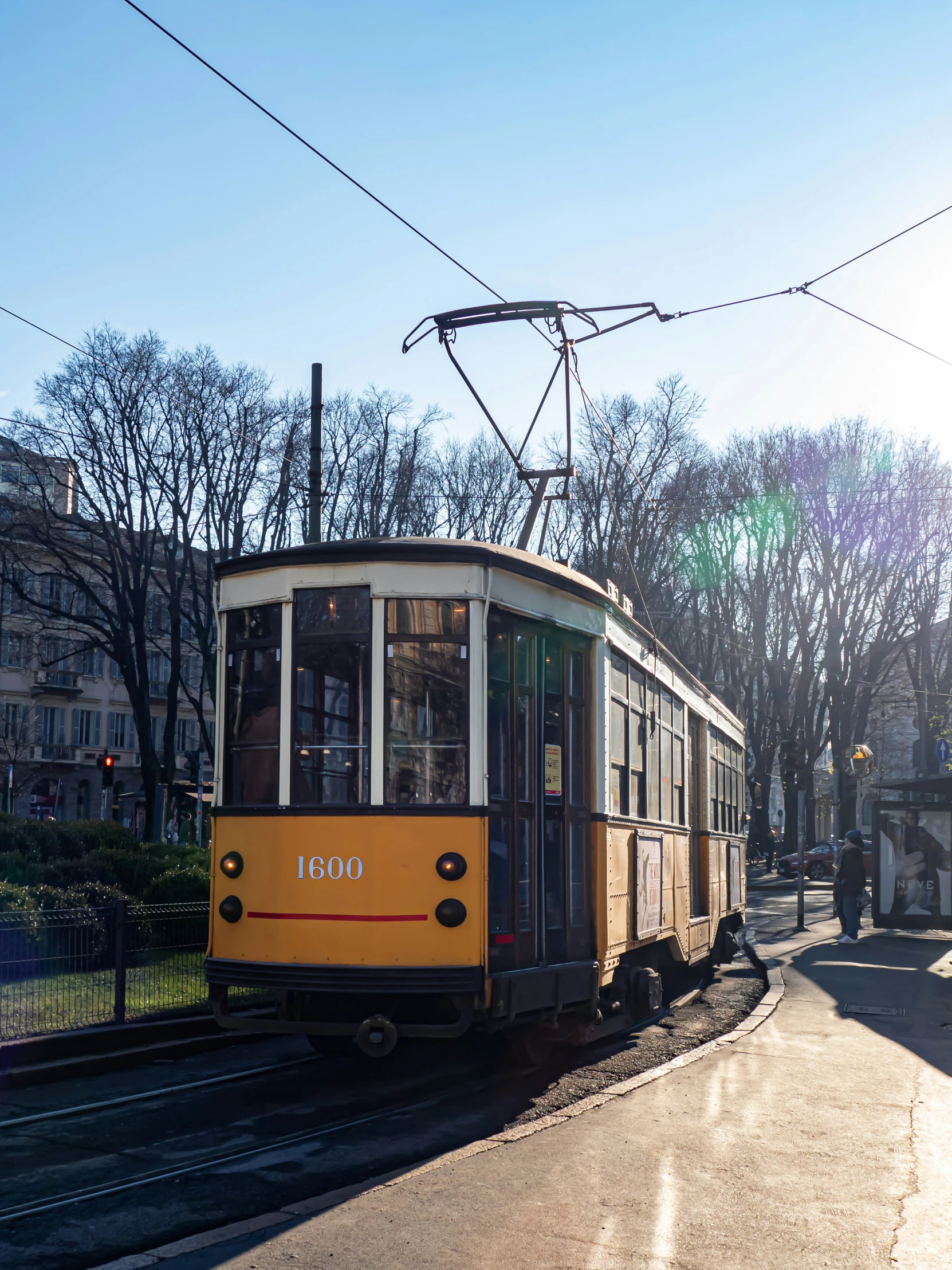 an electric tram in the city on an empty street