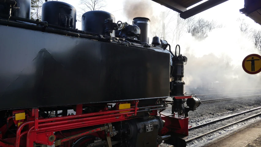 an old locomotive with some steam coming out of it