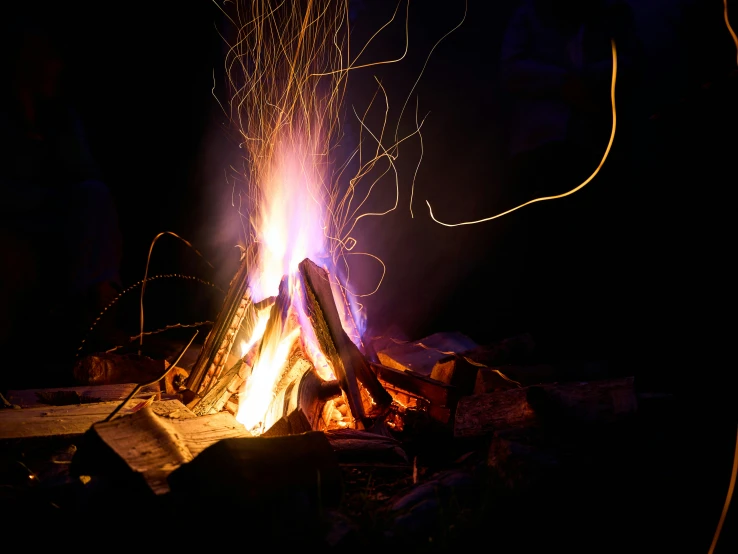 a bonfire lit in the night with its bright fire