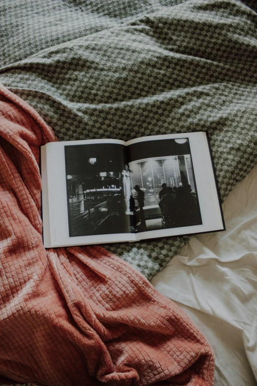 an open book sitting on top of a bed