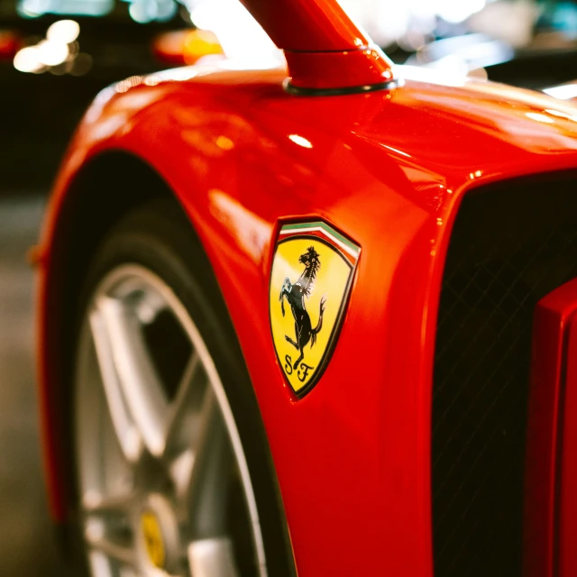 ferrari logo on the side of a red sports car