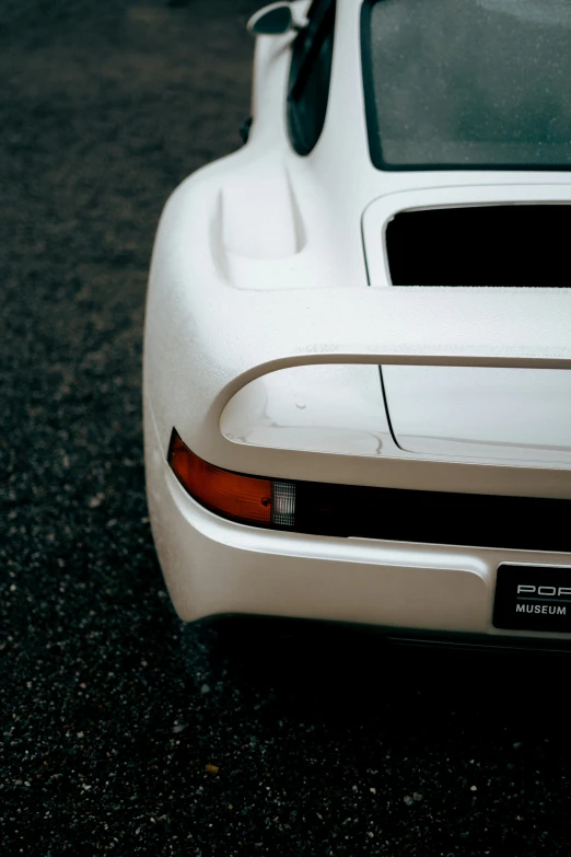 the rear end of a sports car that appears to have been paint job on