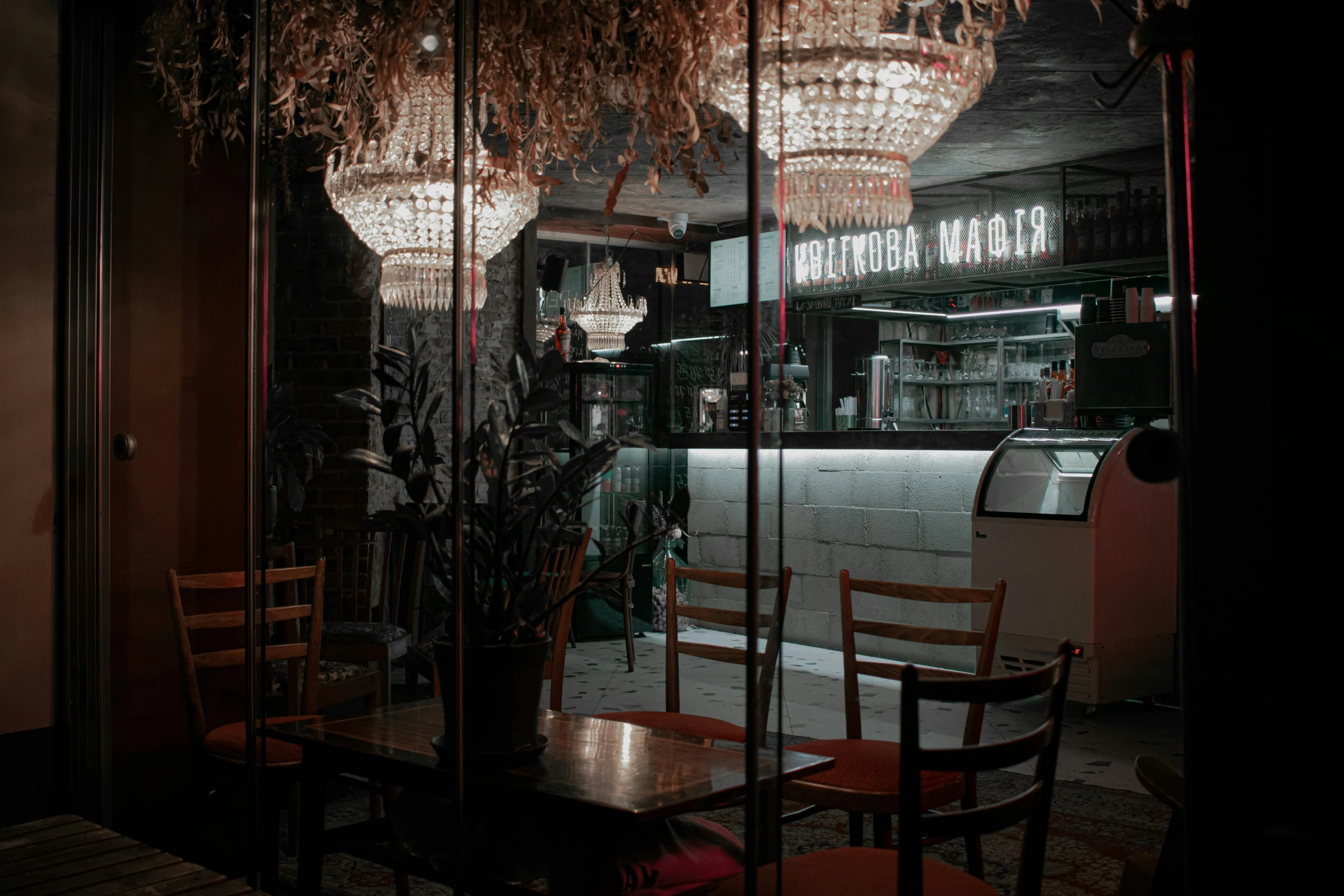 a restaurant inside the darkness with a fancy chandelier