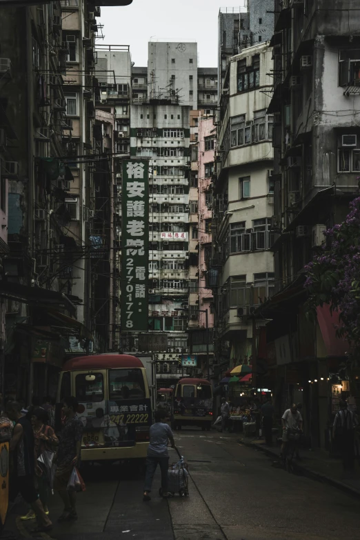 a narrow city street with many tall buildings