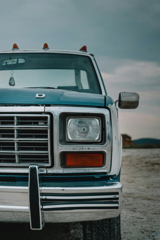 an old pickup truck sits on the gravel