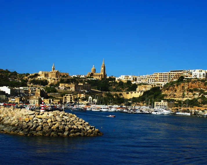 boats on the river with old houses in the background