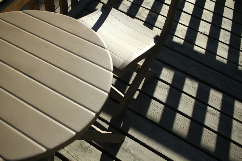 a table sitting next to two chairs on a wooden floor