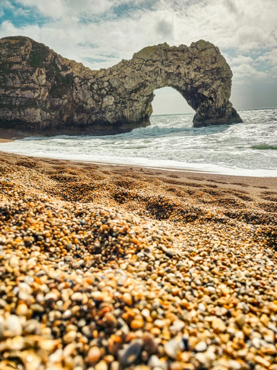 the rocks are arranged on a beach beside the ocean