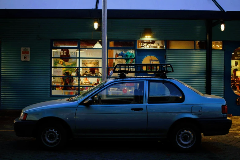 a car is parked outside a shop at night