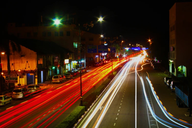 many cars are driving down the road at night