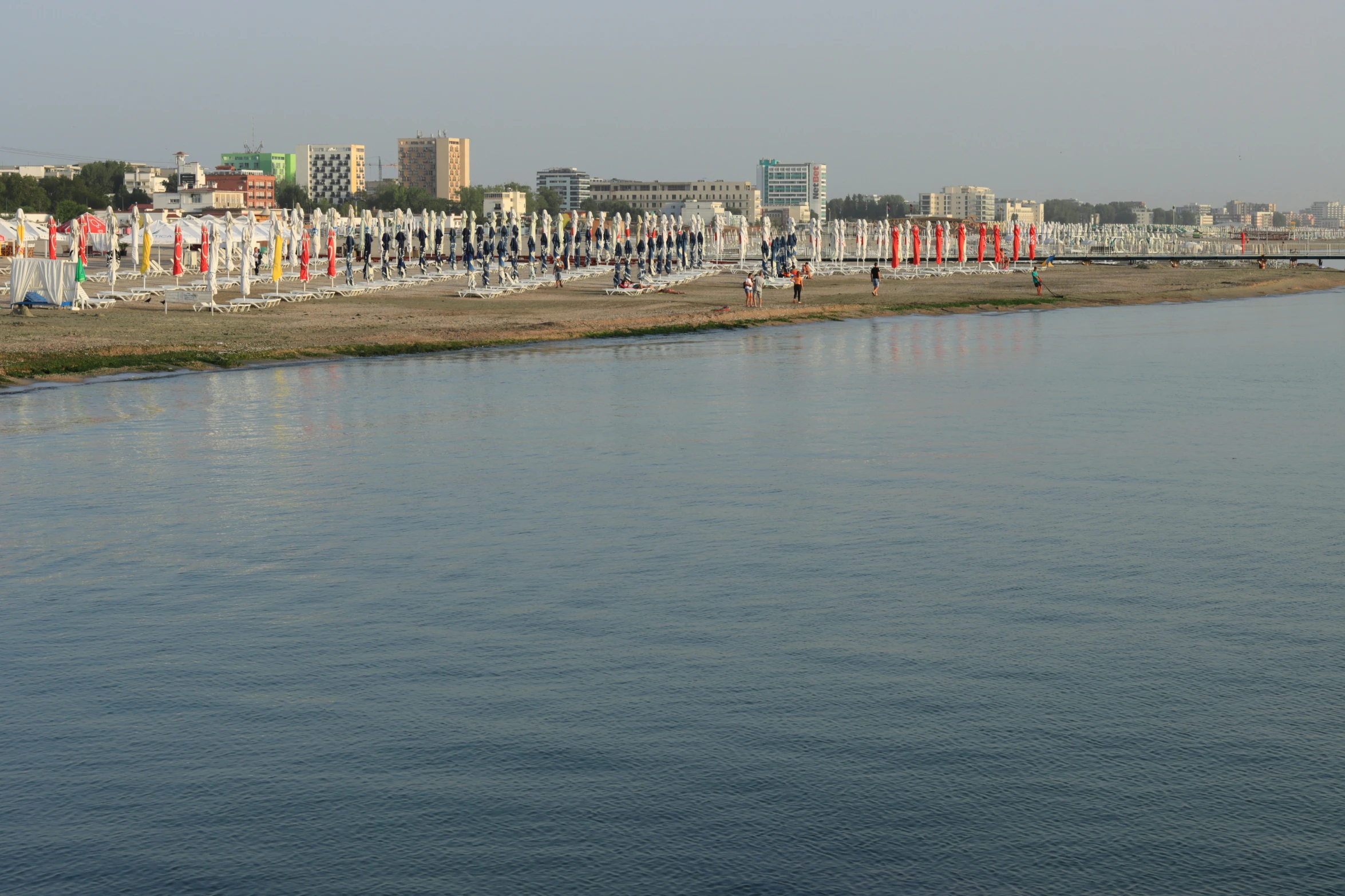 a body of water next to tall buildings