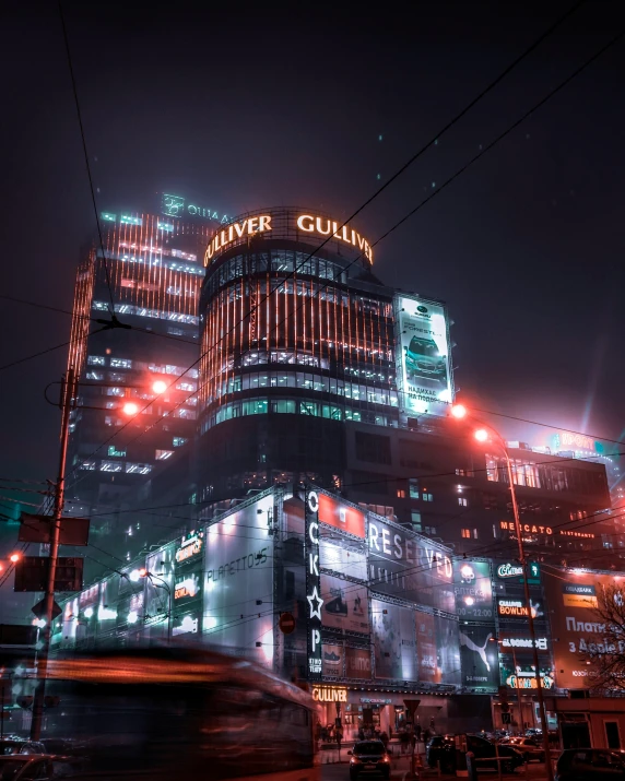 a night view of a tall skyscr with an advertit for a tower gum