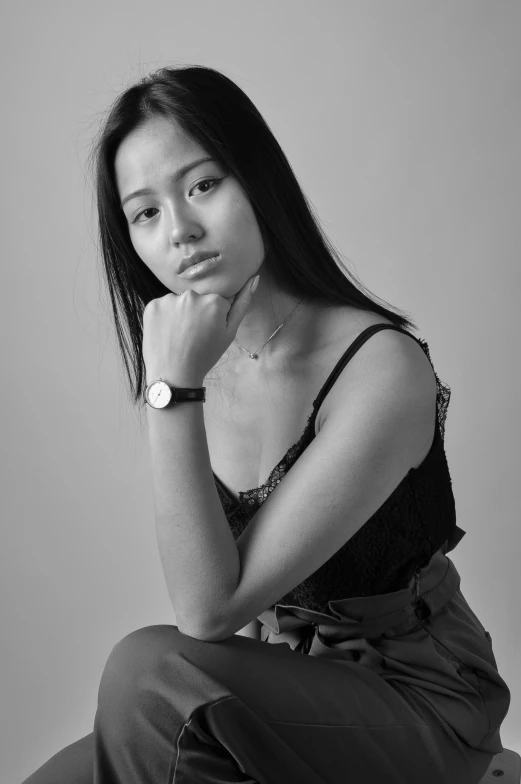 young asian lady posing for portrait with her hands on the cheek