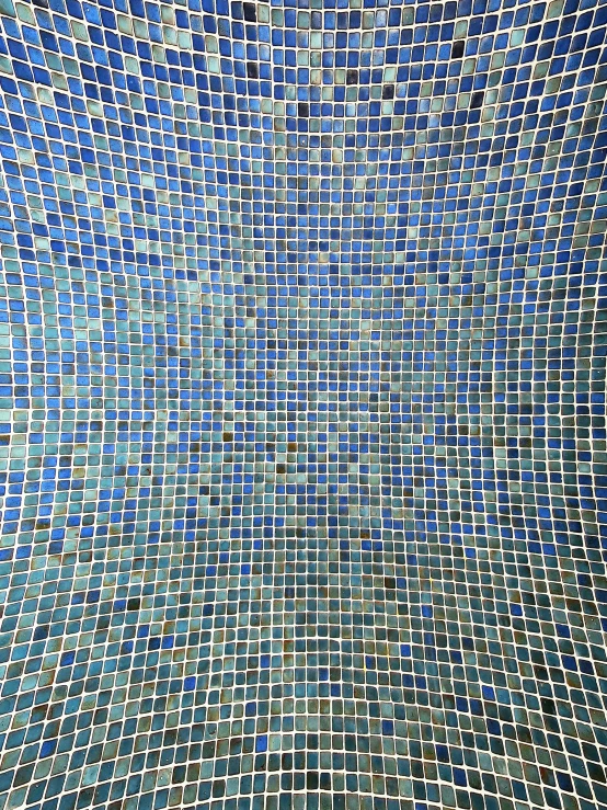 blue tiled bathroom wall with no shower curtain