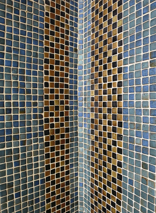 a brown and black tile shower in a tiled room