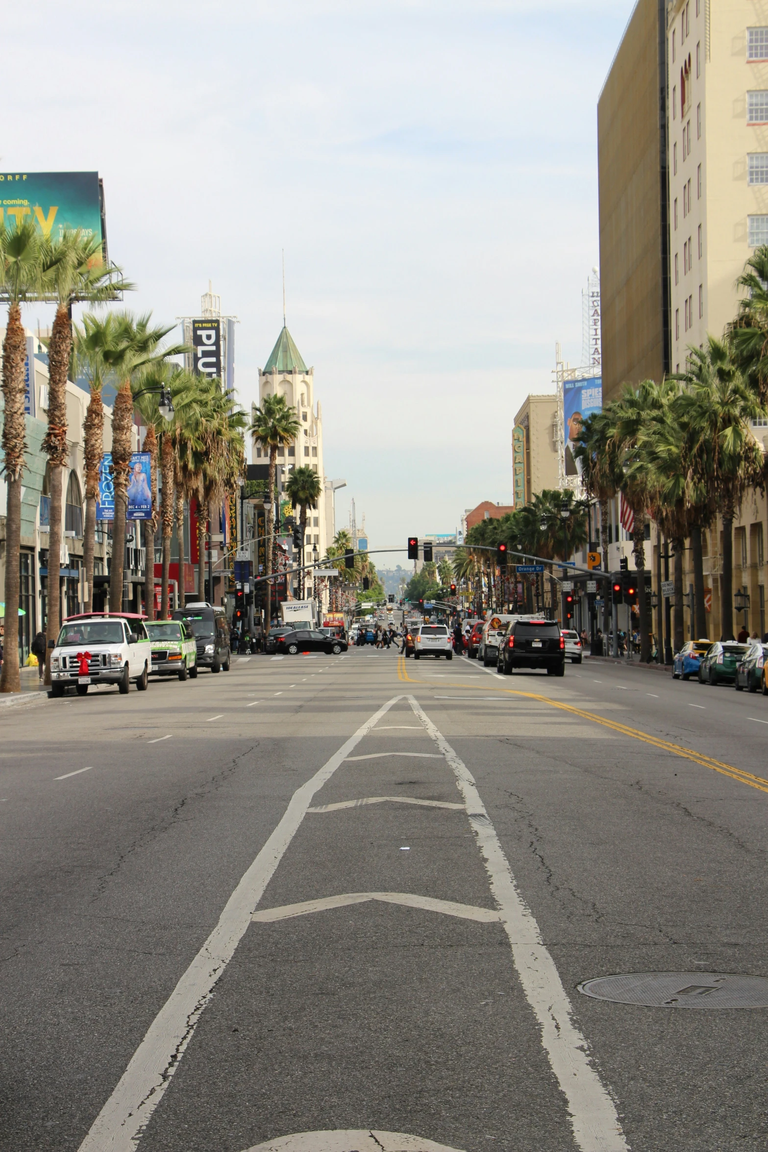 the view down an empty street with palm trees