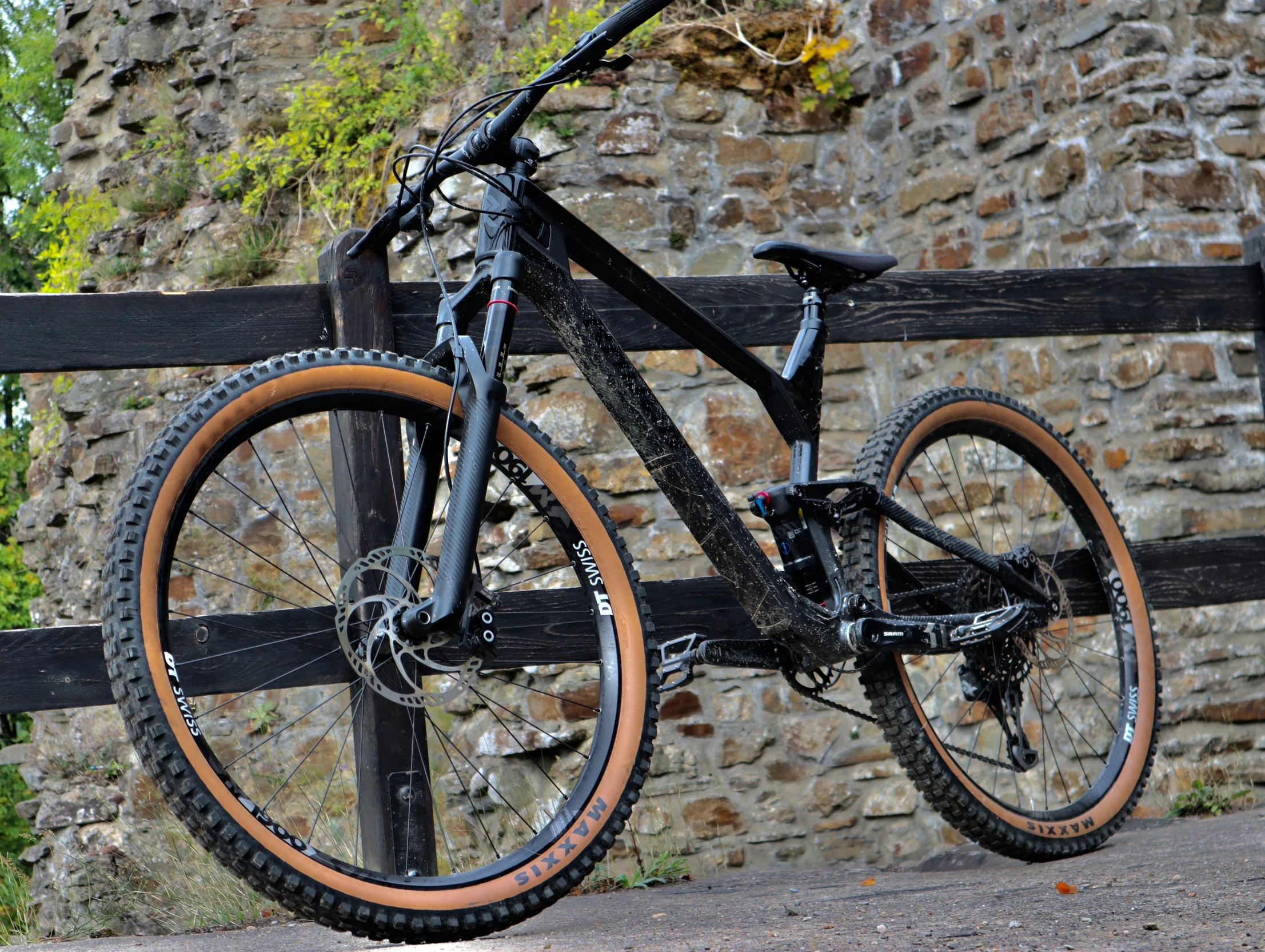 a bike is locked to the railing next to a stone wall