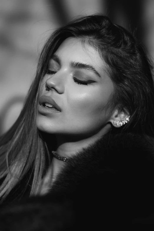 a woman wearing earrings and a fur coat