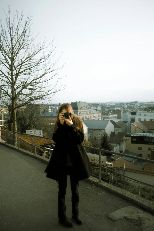 a woman posing in front of a city