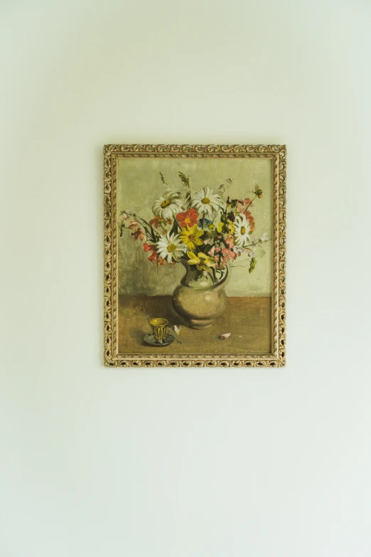 a painting mounted on the wall displaying flowers