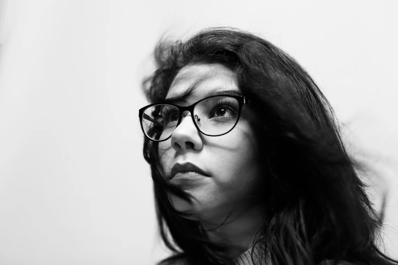 a black and white po of a young woman with eyeglasses