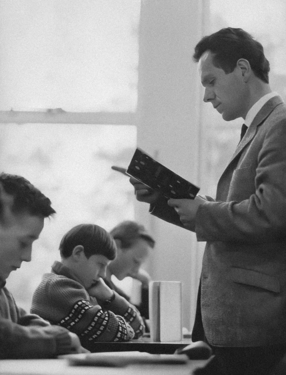 an old po of a man holding up a book