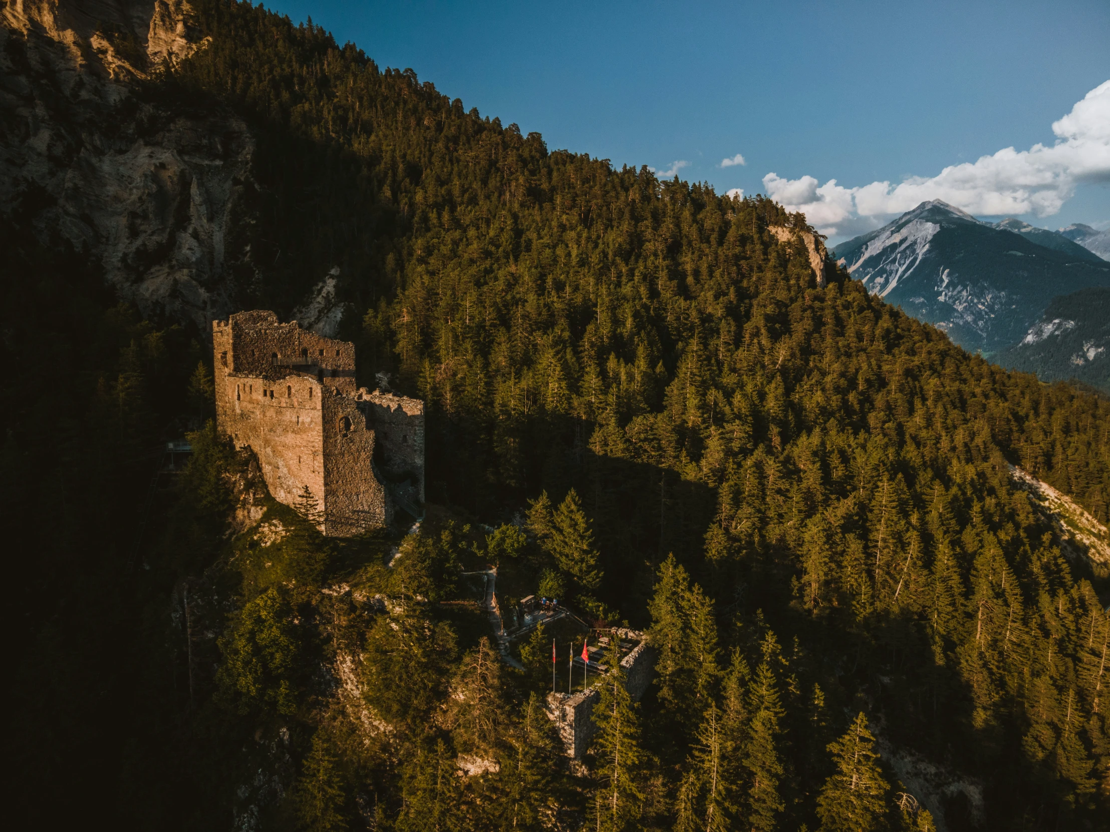 a tall castle perched on the top of a mountain