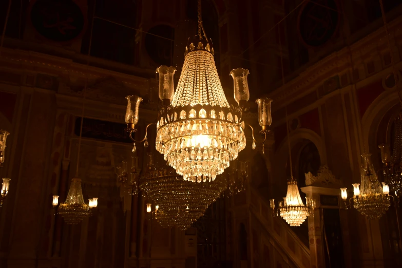 a chandelier in a building has some lights on it