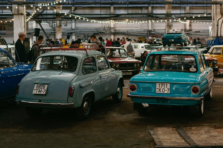 antique cars are parked in an indoor garage