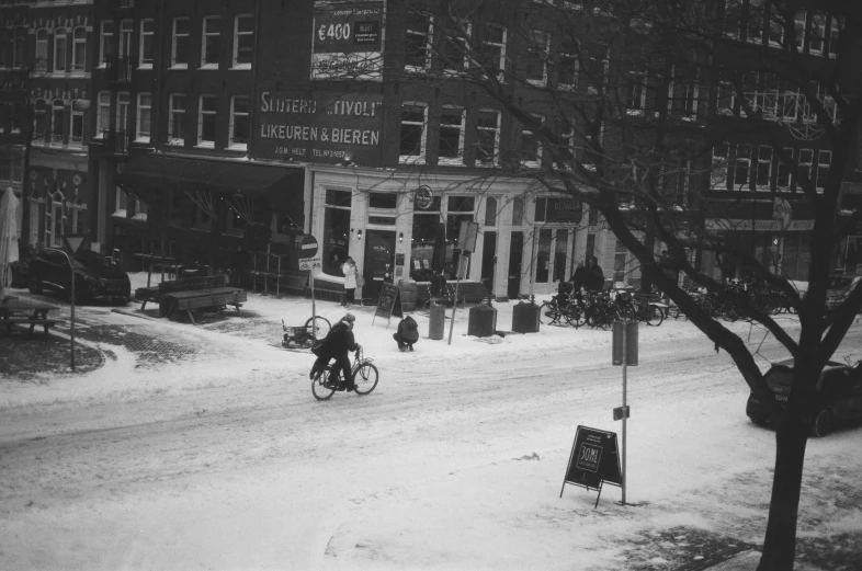 the cyclist is going down the snowy road