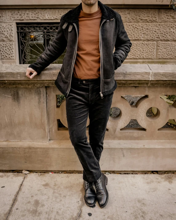 a man posing for a picture in front of a building