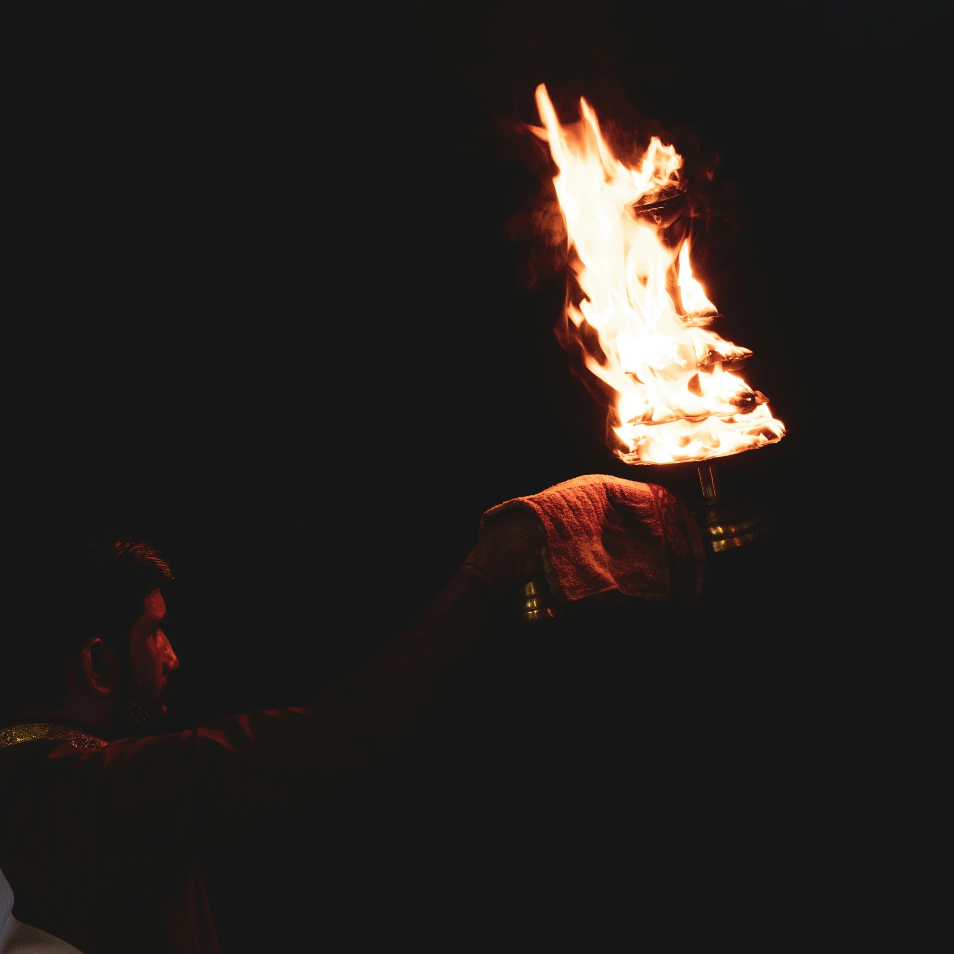 someone holding a lit lit candle in their hand