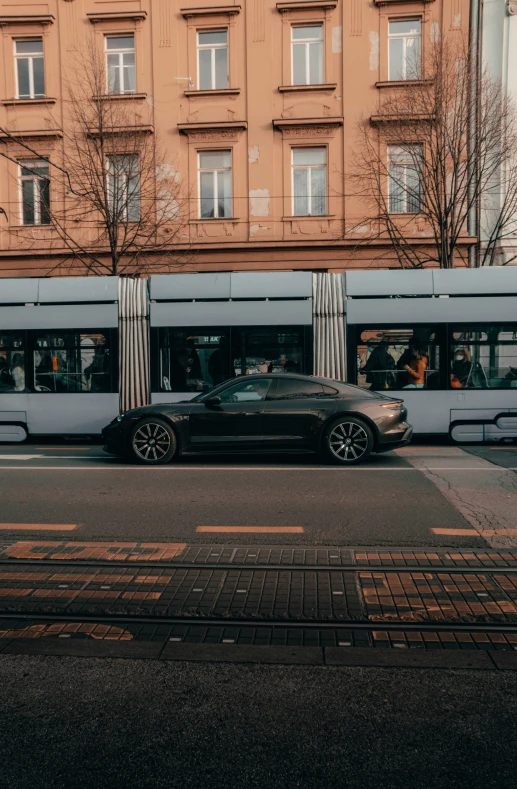 a sports car parked in front of an old building