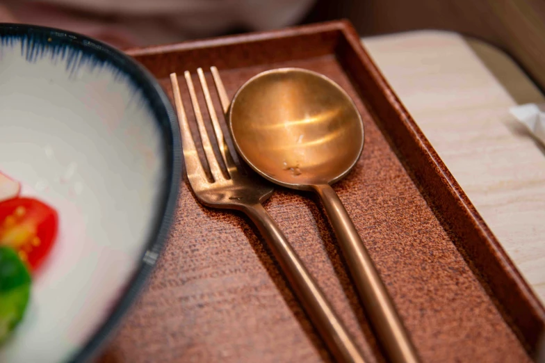 an empty wooden box with silverware sitting on top