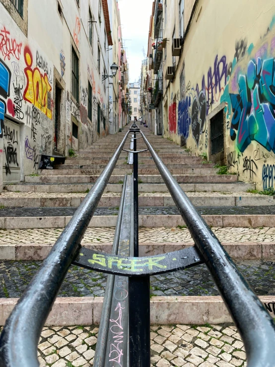 the view down a street that is covered in grafitti