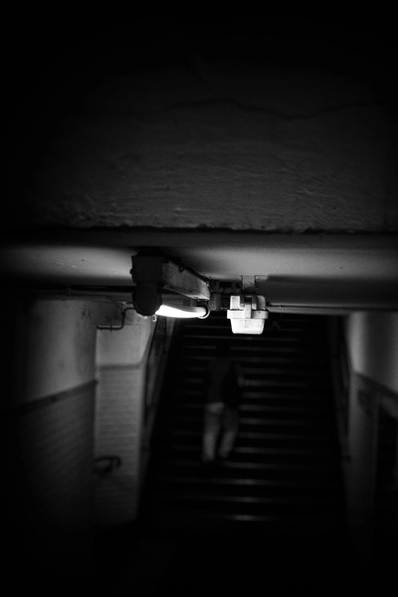 person climbing up a flight of stairs at night