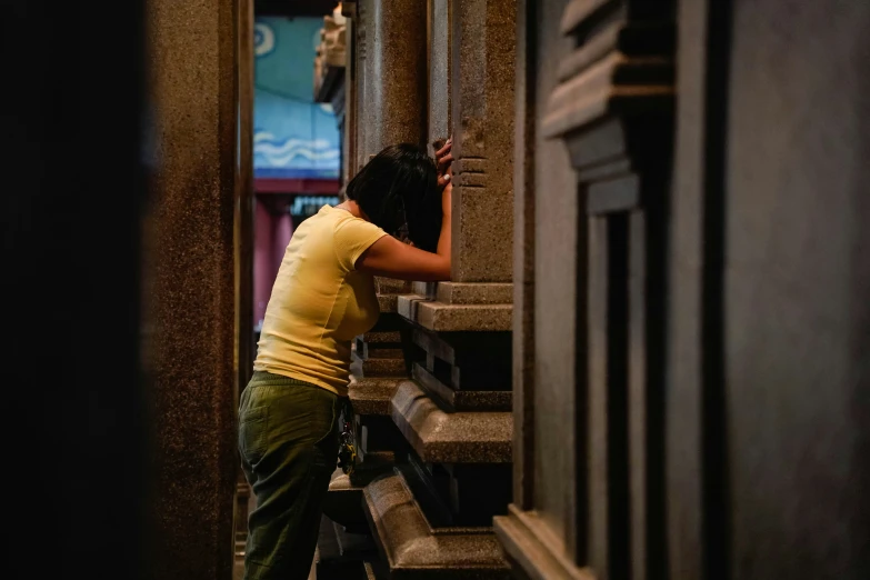 a woman is opening the side of a building