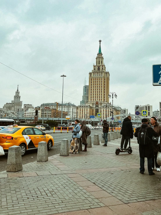 a city street scene with pedestrians and yellow taxis