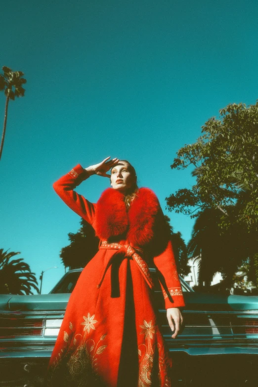 a woman in a red gown poses for the camera