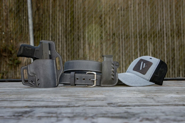 several hats and leather gloves on wooden boards