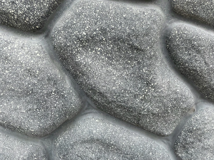 a close up image of black stones