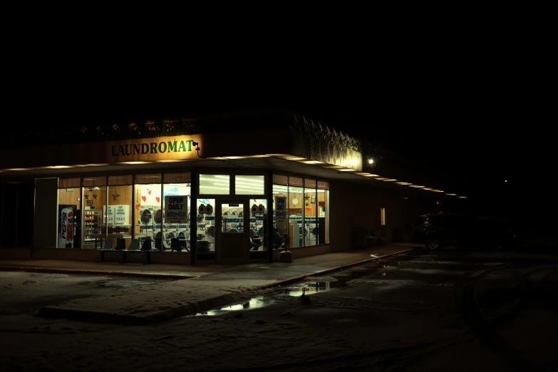 a night scene showing a store front at a mall