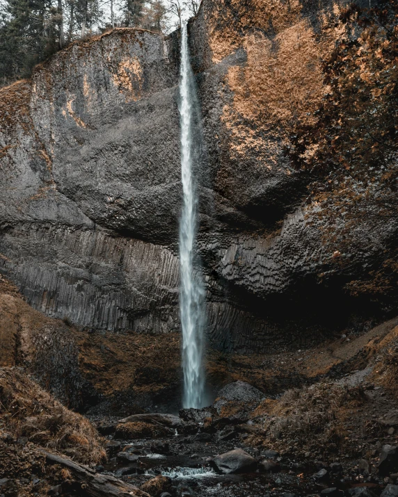 a waterfall coming into a rocky landscape in black and white