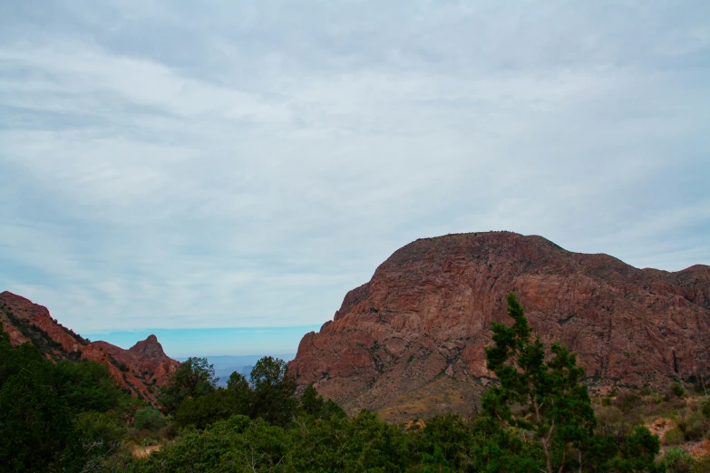 the mountains are surrounded by trees and bushes