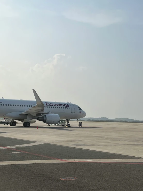 an airplane sitting on the tarmac waiting for passengers